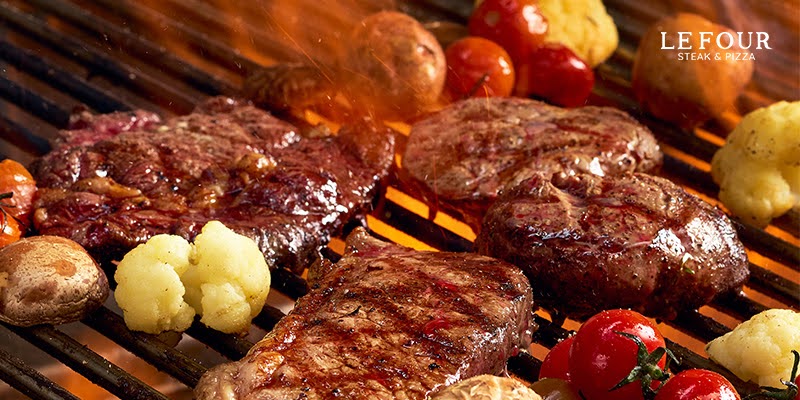 Delicious Danang Beef Steak – The Perfect Combination Between Premium Beef and Standard Grilling Art 5 Grilled beefsteak on open flame with vegetables, representing steak restaurant choices in Da Nang