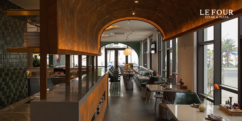 Delicious Danang Beef Steak – The Perfect Combination Between Premium Beef and Standard Grilling Art 2 European-style interior of Le Four Steak & Pizza restaurant in Da Nang with warm lighting and wooden furniture